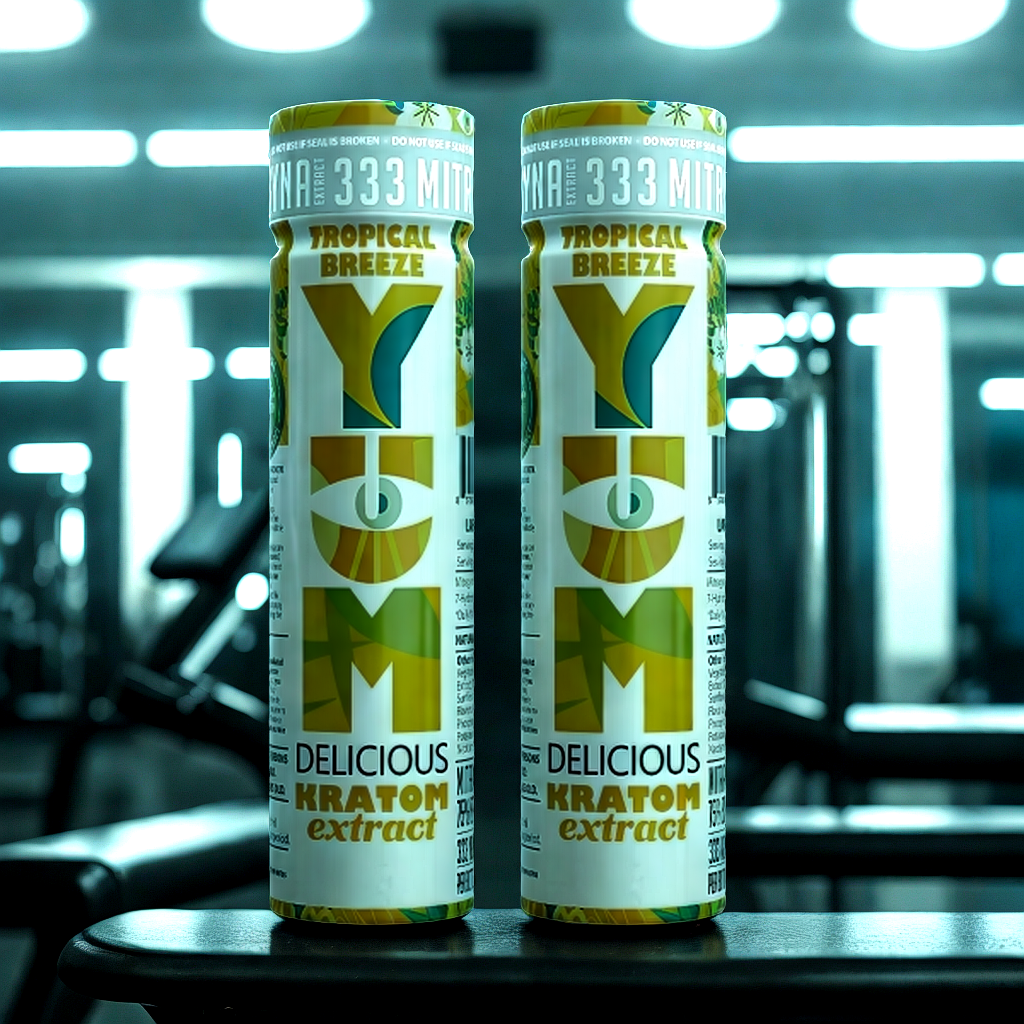 YUM Tropical Breeze kratom shots displayed in gym setting for pre-workout ritual